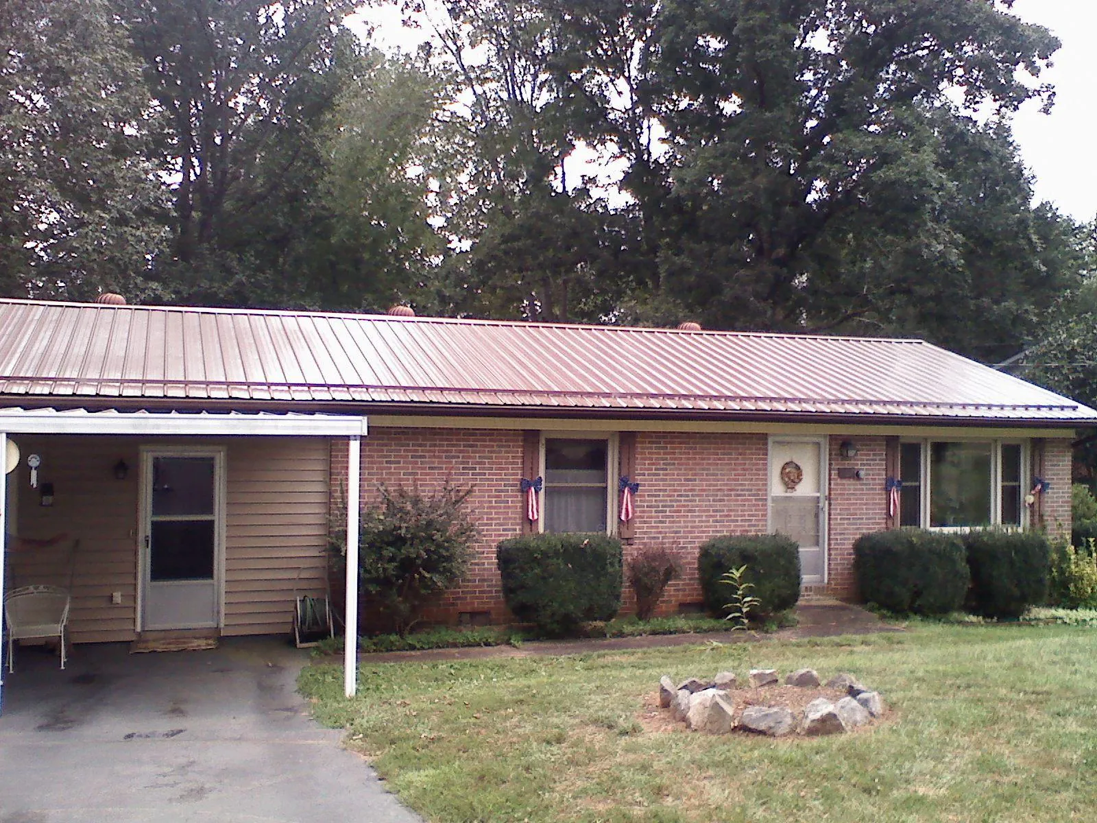 Bronze metal roof and carport on a brick ranch home — Roof Repair work by our crew in Hockessin