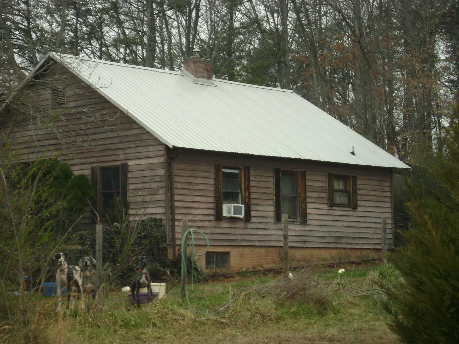 White metal roof on an old wood sided farmhouse, from a Metal Roof Installation job in Hockessin